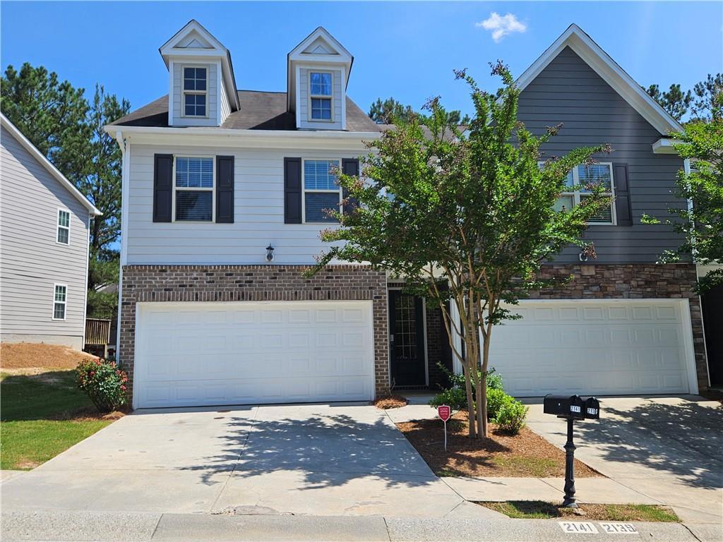 2141 Spikerush Way, Buford, GA 30519 - view of front of property with an attached garage, concrete driveway, and brick siding