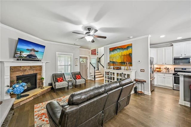 4571 Academy St, Acworth, GA 30101 - living room with crown molding, a ceiling fan, a stone fireplace, recessed lighting, and dark wood finished floors
