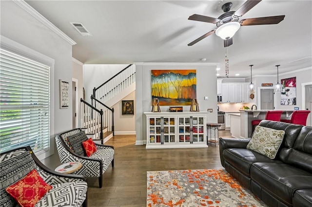 4571 Academy St, Acworth, GA 30101 - living area with ornamental molding, a ceiling fan, wood finished floors, and stairs