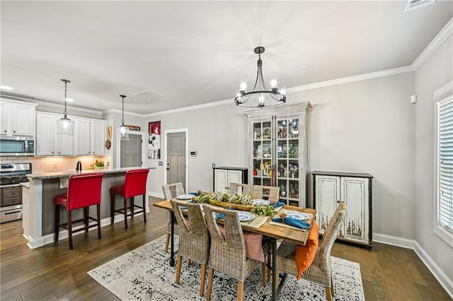 4571 Academy St, Acworth, GA 30101 - dining room with healthy amount of natural light, dark wood-style flooring, a chandelier, and ornamental molding