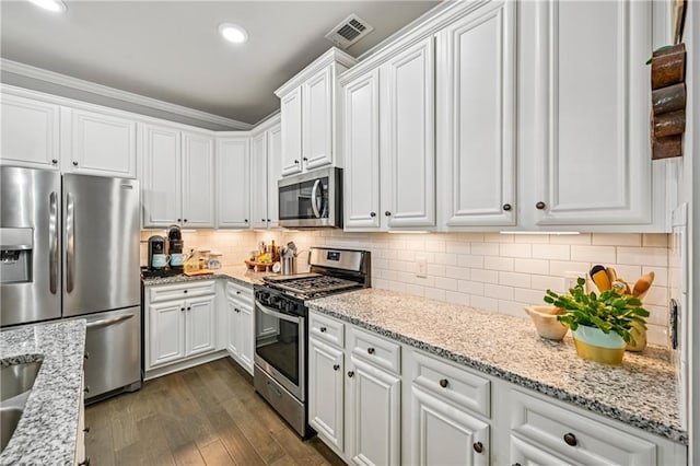 4571 Academy St, Acworth, GA 30101 - kitchen with stainless steel appliances, white cabinetry, dark wood-style flooring, light stone counters, and recessed lighting