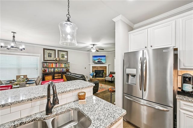 4571 Academy St, Acworth, GA 30101 - kitchen featuring stainless steel refrigerator with ice dispenser, a ceiling fan, crown molding, white cabinetry, and hanging light fixtures