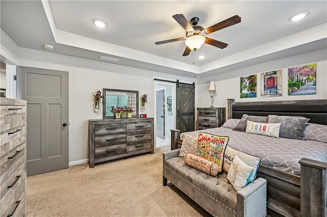 4571 Academy St, Acworth, GA 30101 - bedroom with a barn door, light colored carpet, a tray ceiling, recessed lighting, and a ceiling fan