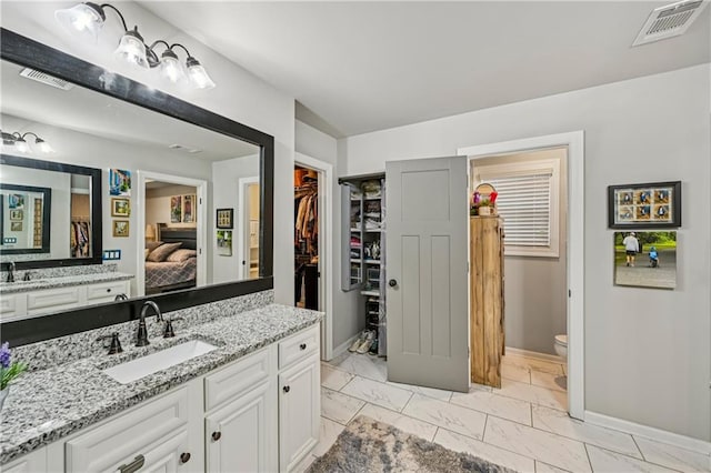 4571 Academy St, Acworth, GA 30101 - full bathroom with marble look tiles, connected bathroom, vanity, and a spacious closet