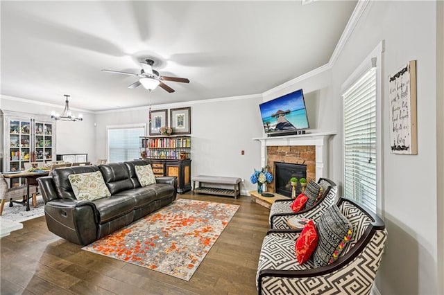 4571 Academy St, Acworth, GA 30101 - living area with a chandelier, a ceiling fan, wood-type flooring, ornamental molding, and a stone fireplace