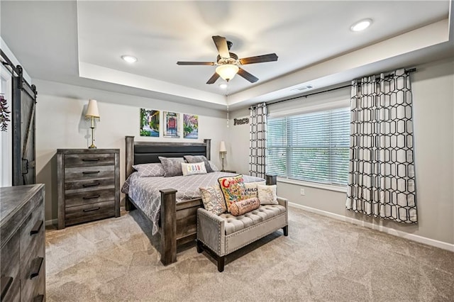 4571 Academy St, Acworth, GA 30101 - bedroom featuring light carpet, a barn door, a tray ceiling, recessed lighting, and ceiling fan