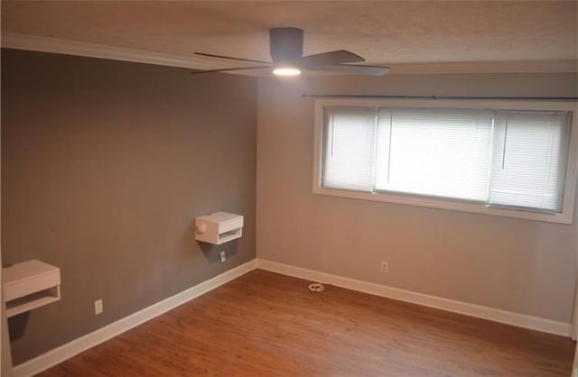 spare room with crown molding, hardwood / wood-style floors, and ceiling fan