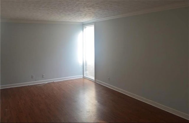 unfurnished room featuring dark hardwood / wood-style flooring, ornamental molding, and a textured ceiling