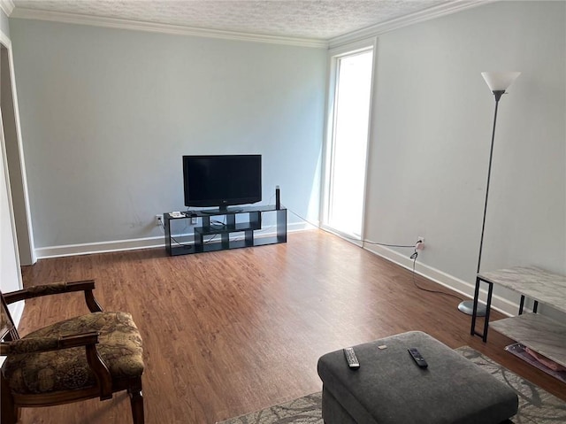 living room with wood-type flooring, ornamental molding, and a textured ceiling