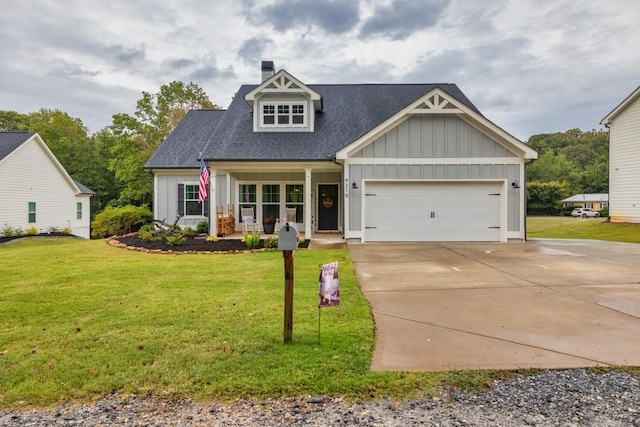 view of front of property featuring a front lawn, covered porch, and a garage