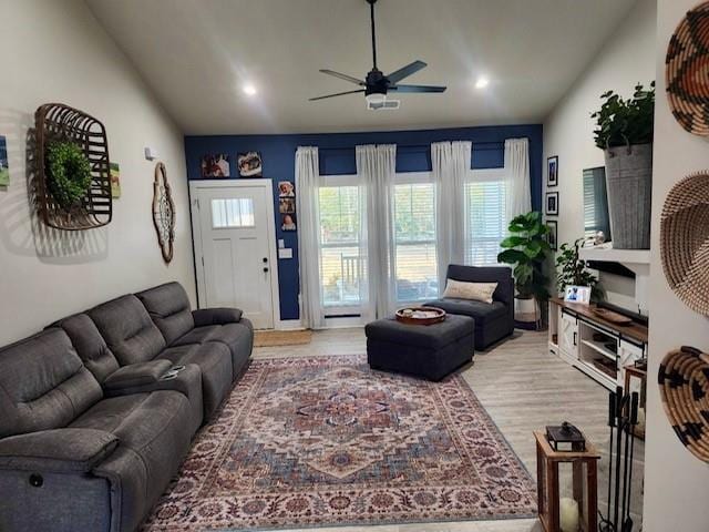 living room with ceiling fan and light hardwood / wood-style flooring