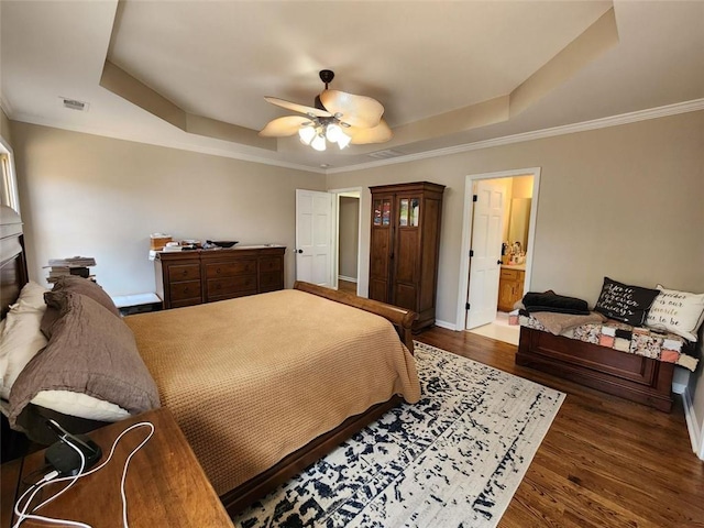 bedroom featuring dark wood-style floors, ceiling fan, a tray ceiling, and visible vents