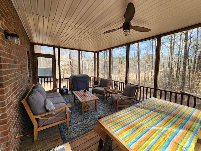 sunroom featuring ceiling fan