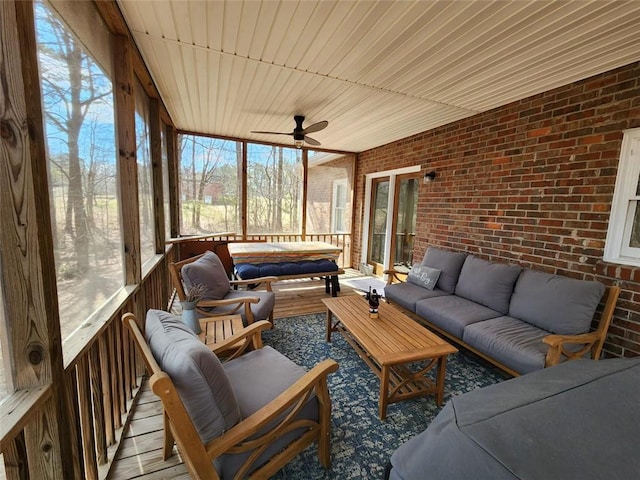 sunroom / solarium featuring ceiling fan