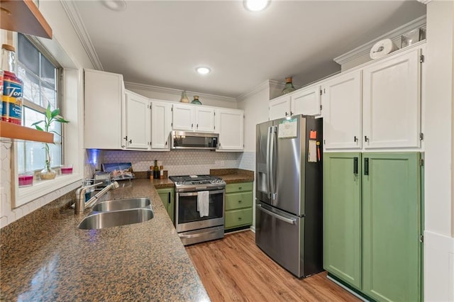 kitchen featuring sink, stainless steel appliances, crown molding, decorative backsplash, and white cabinets