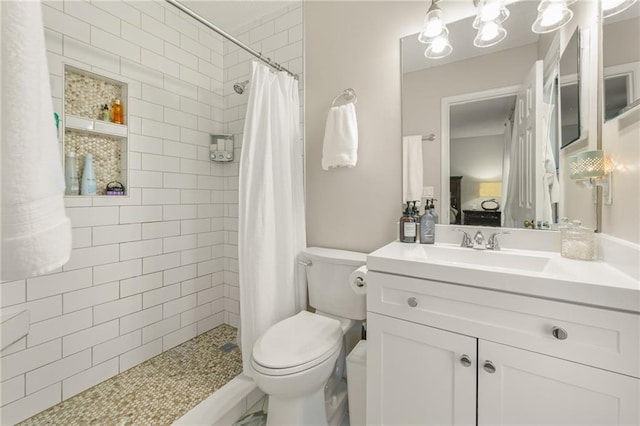 bathroom featuring a shower with curtain, vanity, and toilet