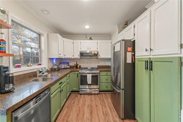 kitchen featuring appliances with stainless steel finishes, backsplash, white cabinetry, and sink