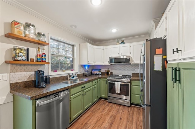 kitchen featuring green cabinets, white cabinetry, sink, and stainless steel appliances