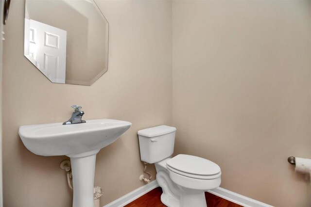 bathroom featuring toilet and hardwood / wood-style flooring