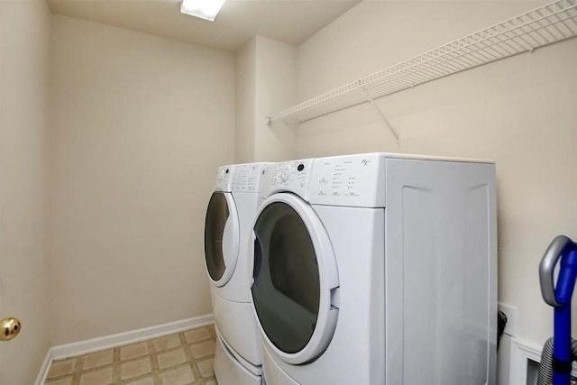 laundry room featuring washer and dryer, laundry area, baseboards, and tile patterned floors