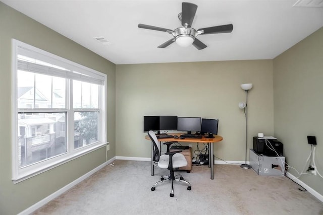 office featuring carpet, visible vents, baseboards, and ceiling fan