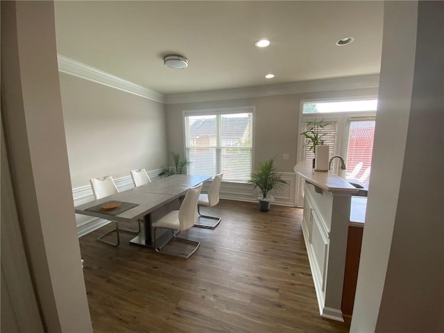 dining space with recessed lighting, a decorative wall, dark wood-style flooring, ornamental molding, and wainscoting