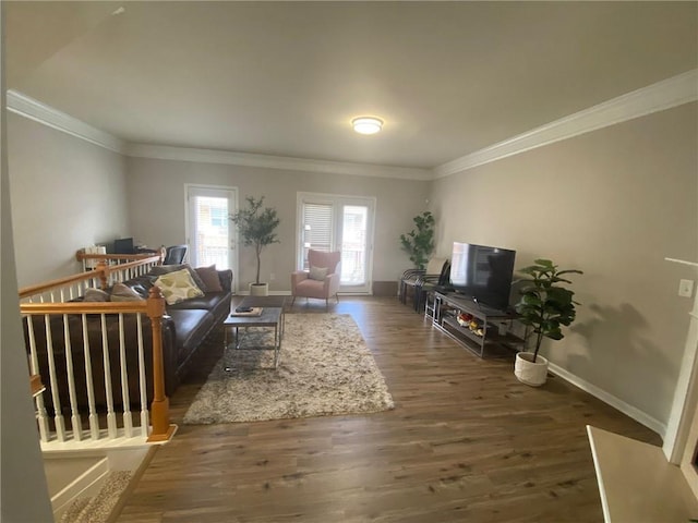 living room with ornamental molding, wood finished floors, and baseboards