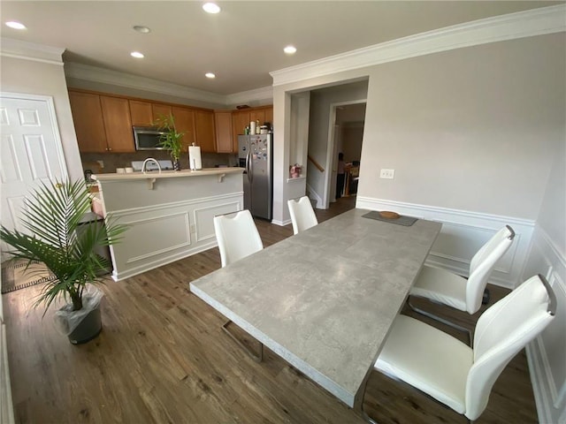 dining room featuring ornamental molding, recessed lighting, dark wood-style flooring, and wainscoting