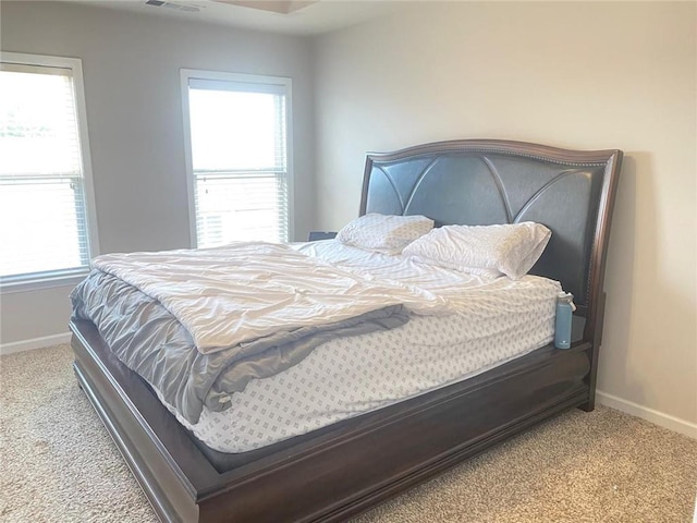 carpeted bedroom featuring visible vents and baseboards