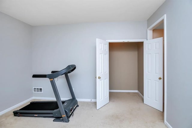 exercise area with carpet floors, visible vents, and baseboards