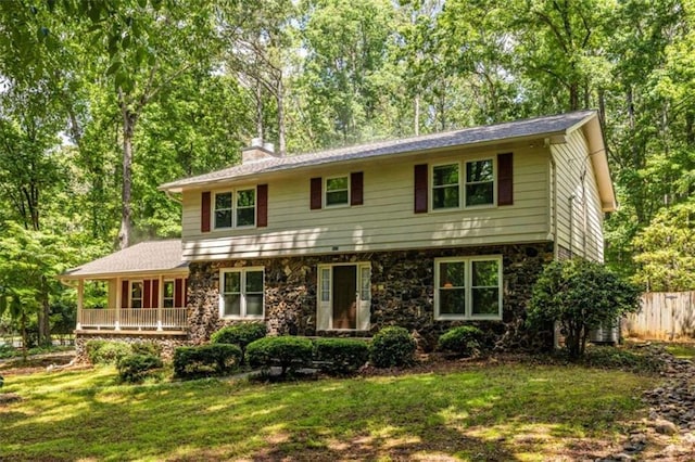 colonial home with a chimney and view of scattered trees