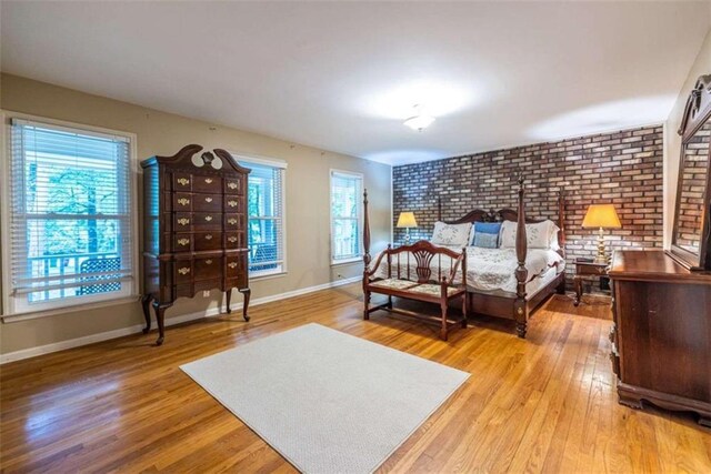 bedroom featuring multiple windows and light wood finished floors