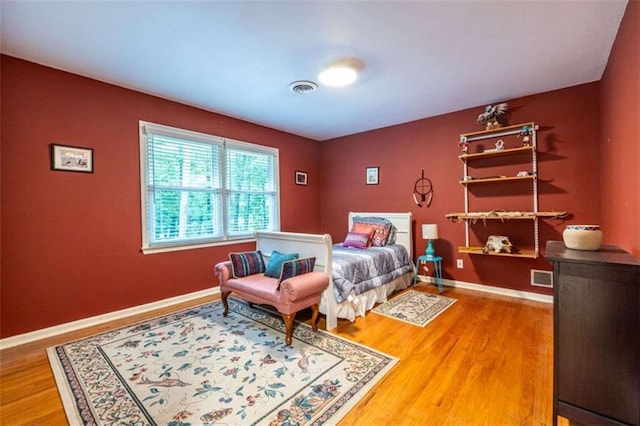 bedroom with wood finished floors and baseboards