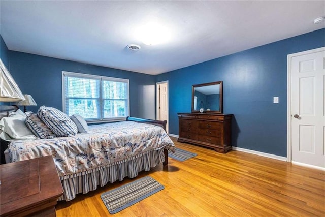 bedroom with wood finished floors and baseboards
