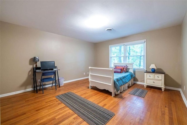 bedroom with wood finished floors and baseboards