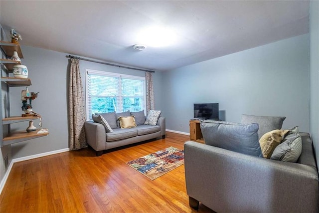 living room featuring wood finished floors and baseboards