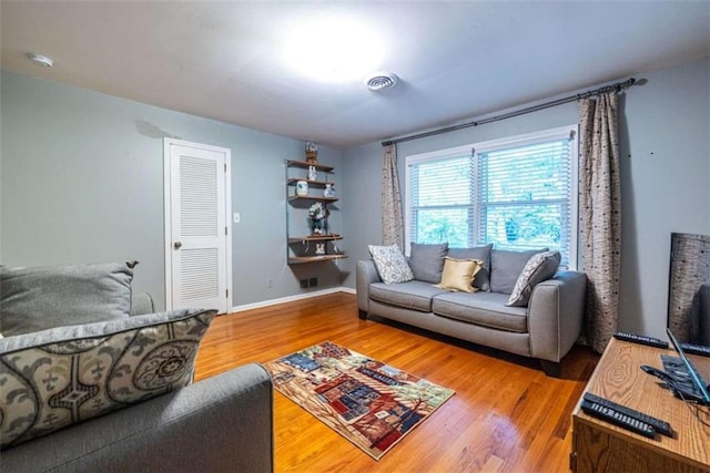 living area featuring wood finished floors and baseboards