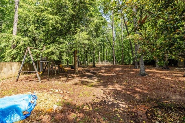 view of yard featuring a playground and fence