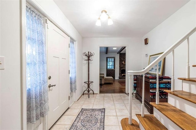entrance foyer with stairs and light tile patterned flooring
