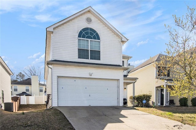 traditional-style house with cooling unit, an attached garage, concrete driveway, and fence