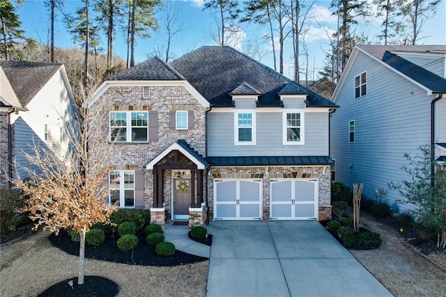 craftsman house with metal roof, an attached garage, brick siding, driveway, and a standing seam roof