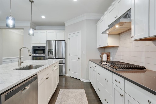 kitchen featuring under cabinet range hood, a sink, white cabinets, appliances with stainless steel finishes, and crown molding