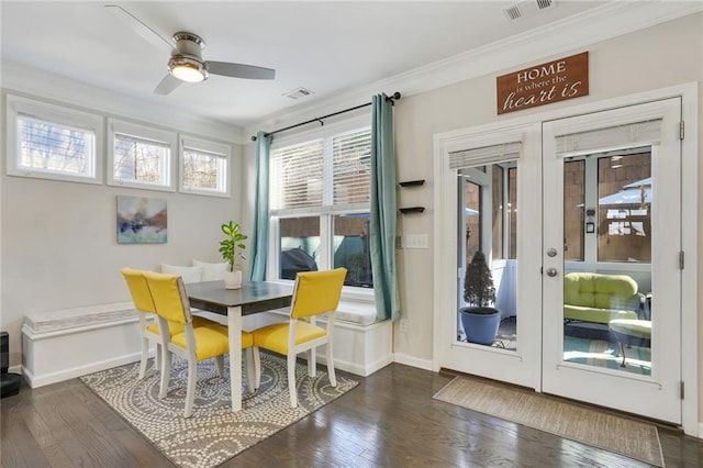 dining area with ornamental molding, french doors, visible vents, and dark wood-style floors