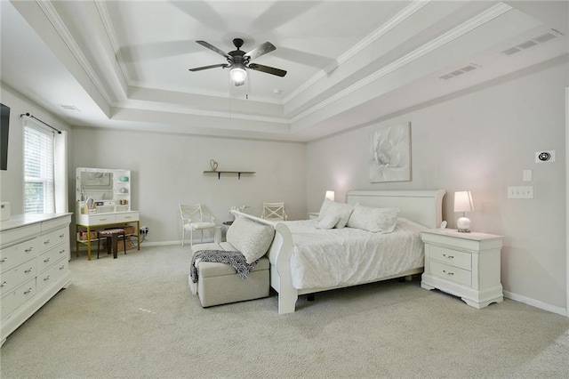 bedroom featuring visible vents, a tray ceiling, crown molding, and light colored carpet