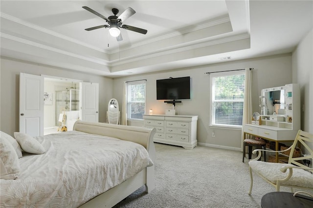 bedroom featuring light carpet, multiple windows, baseboards, and a raised ceiling