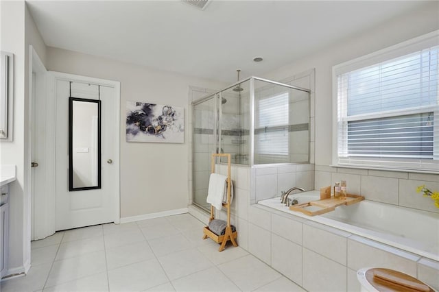 bathroom featuring a stall shower, vanity, tile patterned flooring, baseboards, and a bath