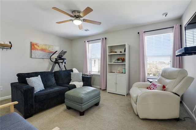 carpeted living room with visible vents, ceiling fan, and baseboards