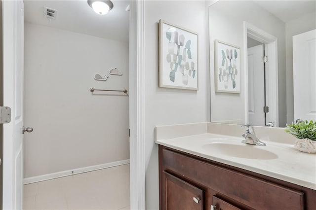 bathroom featuring vanity, visible vents, and baseboards