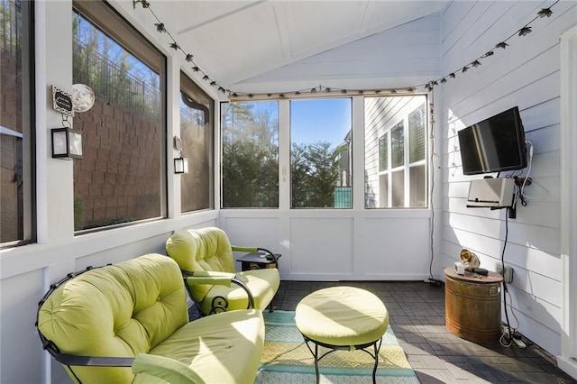 sunroom featuring lofted ceiling