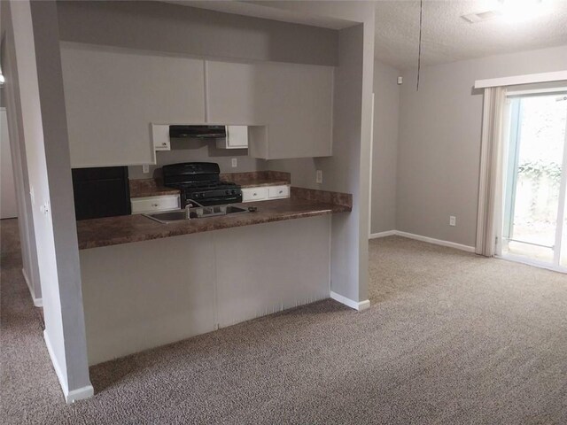 kitchen with black gas stove, a textured ceiling, white cabinets, carpet floors, and ventilation hood